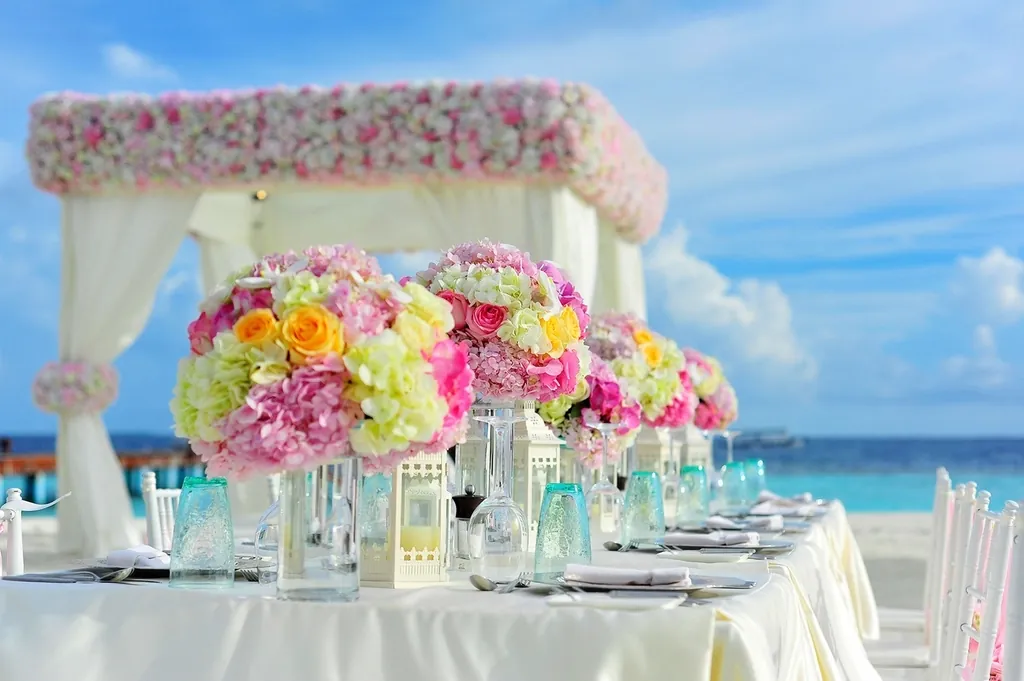 Beach reception under a floral canopy
