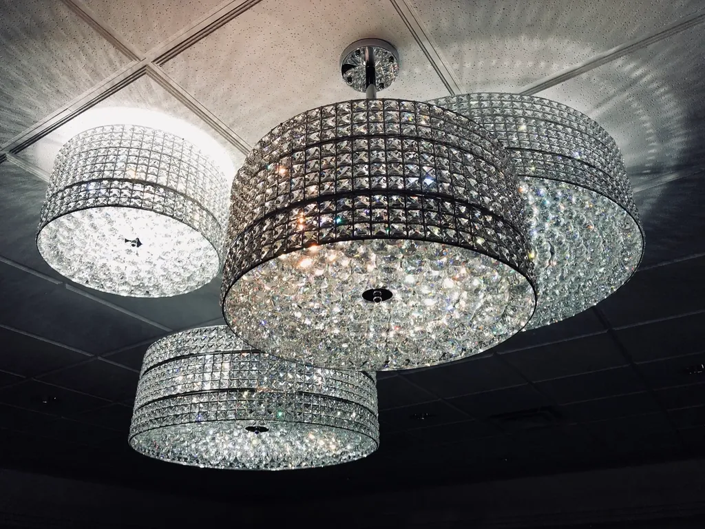 Crystal drum chandelier glowing over a reception