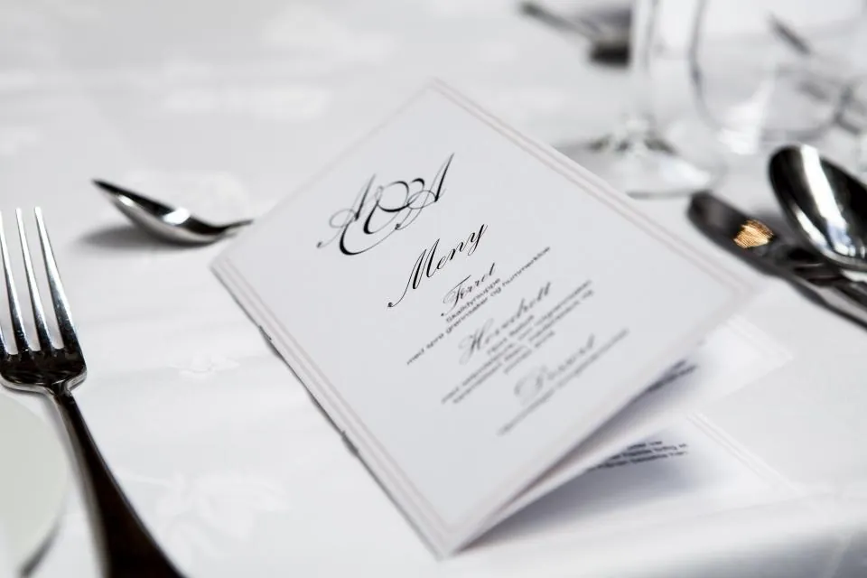 Wedding menu card on a white place setting